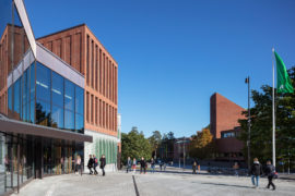 The new square and public space in front of the Aalto University Väre Building for The School of Art, Design and Architecture, designed by Verstas Architects. Alvar Aalto's old main building in the background.